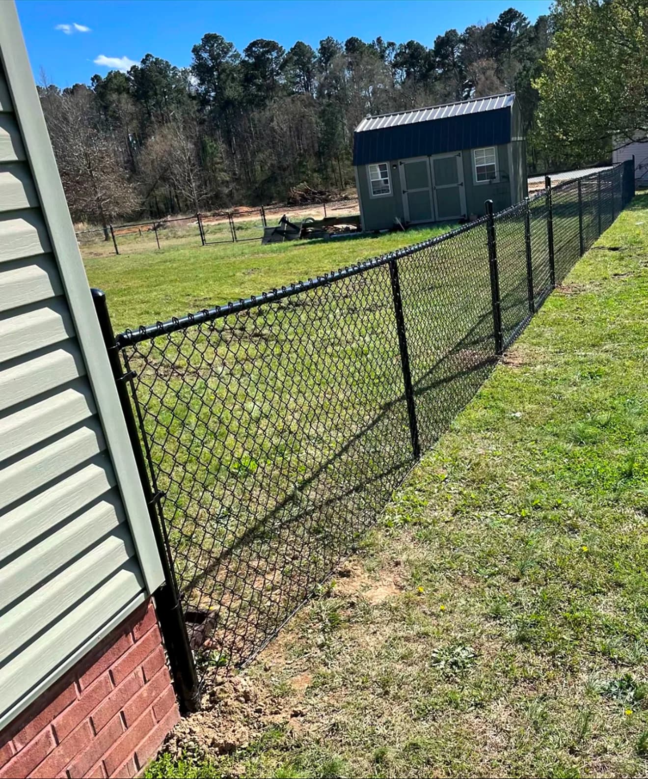 Black Chain Link install by A Class Fencing in Calgary